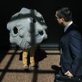 a man walking by a person dressed up as a giant polio virus